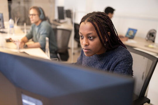 Focused employee working at computer in modern office
