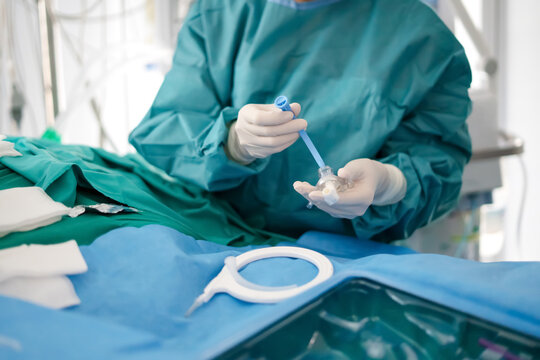 Hands of doctor prepares tracheotomy tube in ICU emergency care