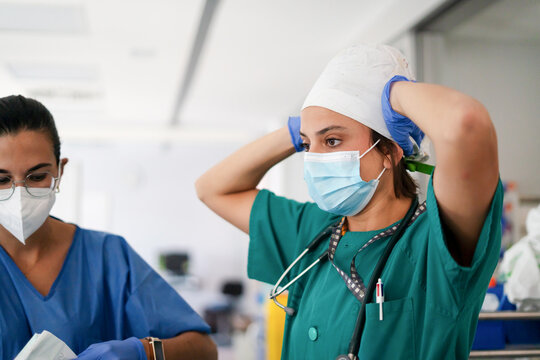 ICU doctor preparing for emergency care in hospital ward