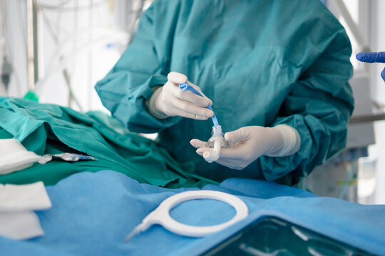 Hands of doctor preparing tracheotomy airway device in ICU emergency