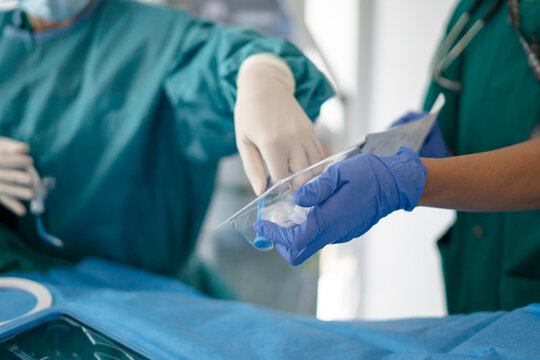 Hand of doctor preparing tracheotomy kit in ICU emergency care