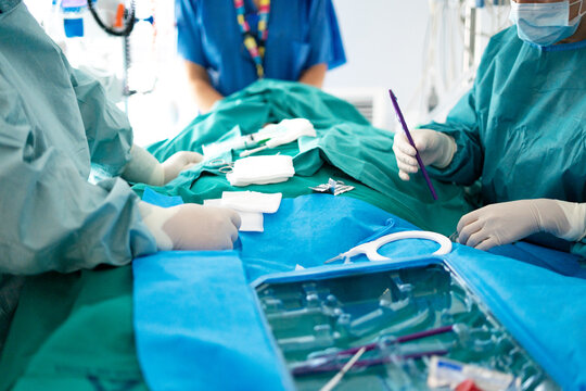 ICU doctor performing emergency tracheotomy procedure
