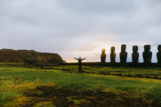 Moai statues and person on Easter Island landscape