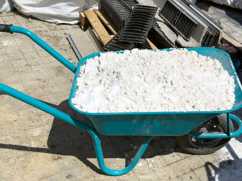 Wheelbarrow filled with construction material on site