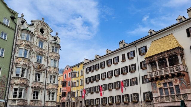 Innsbruck, Austria - May 19, 2023. The historic center with the Golden Roof Goldenes Dachl and Baroque Helbling House Helblinghaus.