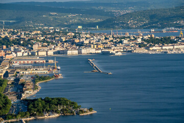 Fototapeta premium Aerial View Of Trieste City Harbour From Napoleonica Hiking Trail - Famous Climbing Bouldering Area, Gulf Of Trieste Adriatic Italy, Panoramic Karst Hillside Overlook