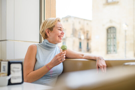 Woman enjoying gelato while slow traveling in Lecce, Puglia
