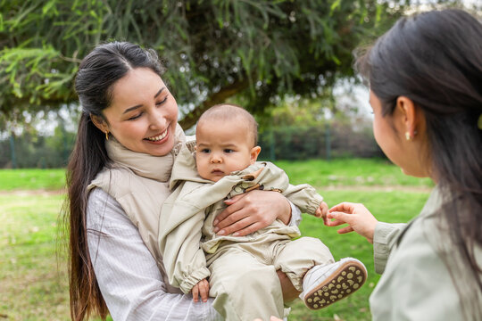 Happy family with a baby enjoying time at the park