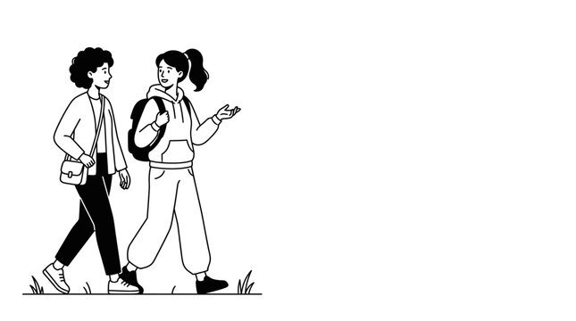 Two young female friends walking and talking together outdoors.