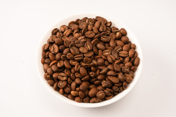 Fototapeta premium Coffee beans on a white background. Top view. Coffee beans texture.