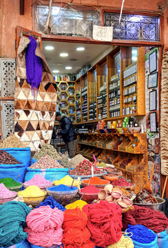 Colorful Moroccan spices and wool yarn in a shop in the Marrakech souk