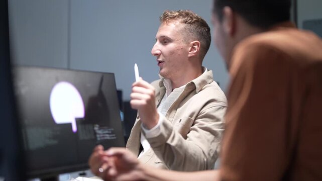 Professional software development team collaborating on coding, debugging, and system architecture analysis in a modern high-tech office environment.