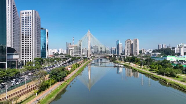 SAO PAULO, BRAZIL - MAY 2026: Aerial view of the Octavio Frias de Oliveira cable-stayed bridge and Marginal Pinheiros highway with river reflection.