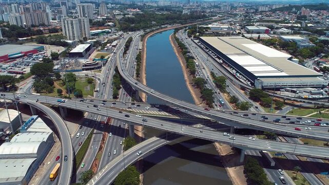 SAO PAULO, BRAZIL - MAY 2026: Aerial view of the Octavio Frias de Oliveira cable-stayed bridge and Marginal Pinheiros highway with river reflection.