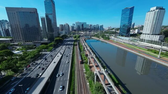 SAO PAULO, BRAZIL - MAY 2026: Aerial view of the Octavio Frias de Oliveira cable-stayed bridge and Marginal Pinheiros highway with river reflection.