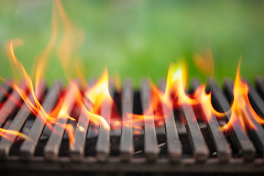 Barbecue grill flames with metal grate close up outdoor