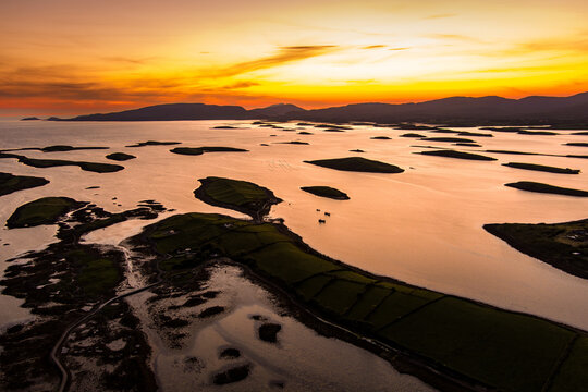 Aerial sunset view over Clew Bay near Westport, County Mayo, Ireland. Scenic Atlantic bay with drumlin islands and mountain silhouettes on the Wild Atlantic Way.