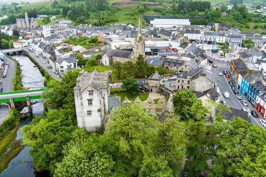Aerial view of Donegal Castle rising above trees in Donegal Town, Ireland. Historic architecture and urban heritage in the heart of County Donegal.