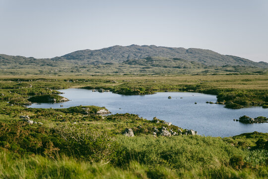 Small bog pools and peatland stretch beside Roundstone Bog Road in Connemara, County Galway. This image captures the wild wetland landscape of western Ireland.