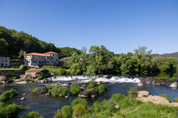Fototapeta premium Pontemaceira historical building and waterfall on tambre river