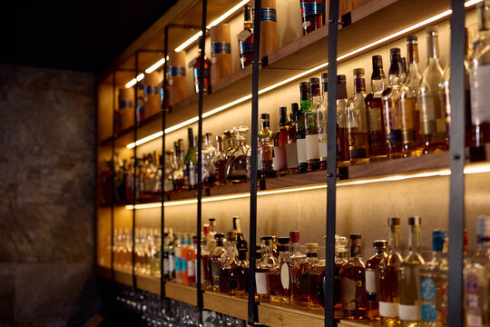 Alcohol beverage collection on shelves in a bar.