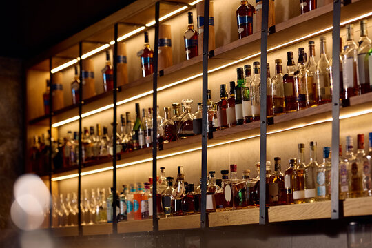 Bar shelves with assorted alcohol bottles.