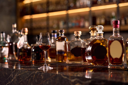 Served whiskey and liquor bottles at bar counter.