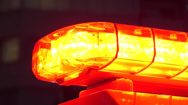 JAPAN : Close up view of a fire truck flashing red emergency lights and siren responding to a rescue mission. Fire engine public safety vehicle detail. Slow motion shot.