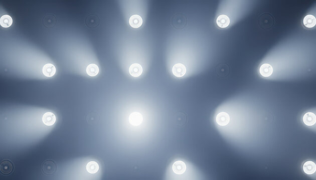 Blue stage lighting with bright spotlights creating atmospheric beams and haze effects. Professional concert or theater lighting setup with glowing fixtures. For entertainment and event backgrounds.
