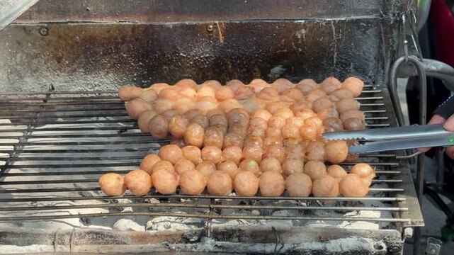 Thai Street Food Sausage Balls Cooking over Hot Coals