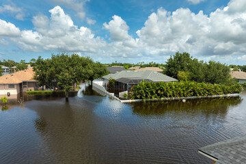 Fototapeta premium Tropical rainstorm flooded residential homes in suburban community in Florida. Hurricane aftermath