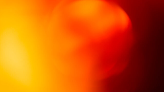 Fiery bokeh background with glowing yellow orange and deep red defocused light circles for dramatic backdrop