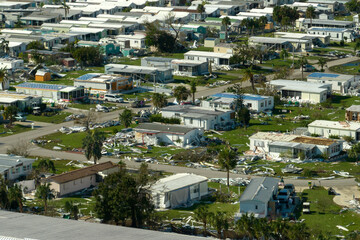 Fototapeta premium Wind damage of private houses after hurricane swept through Florida mobile home residential area. Consequences of natural disaster
