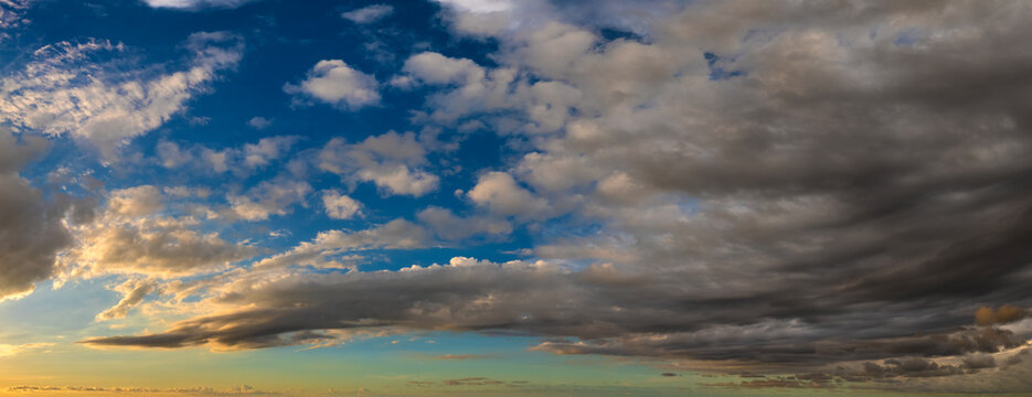Bright colorful orange and yellow clouds on horizon. Beautiful sunset sky scenery