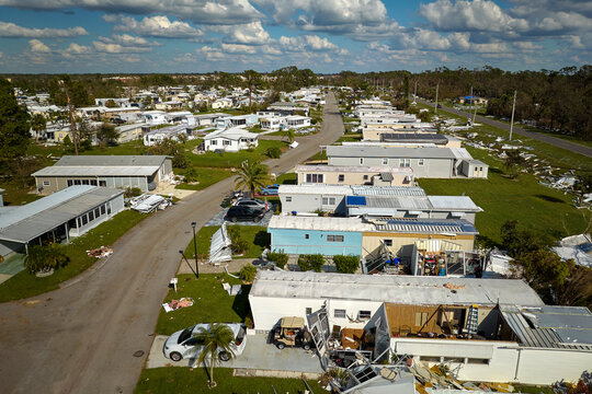 Severely damaged by hurricane Ian houses in Florida mobile home residential area. Consequences of natural disaster