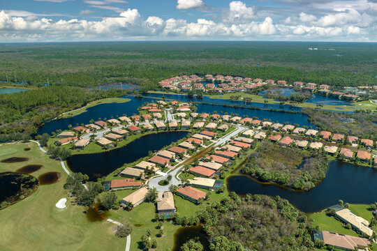Heavy flood with high water surrounding residential houses after hurricane Ian rainfall in Florida residential area. Consequences of natural disaster