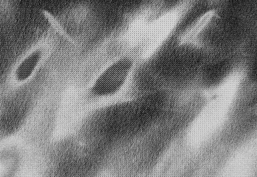 Abstract grayscale noise texture with film grain effect and dramatic light and shadow