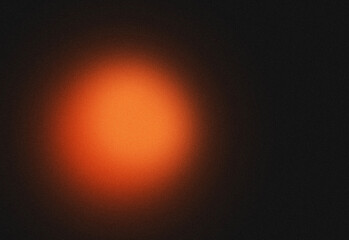 Abstract dark background with warm orange glowing light circle and subtle starry texture © DesignSells