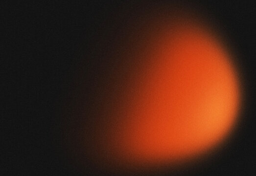 Abstract dark background with warm orange glow and subtle texture, light flare for design