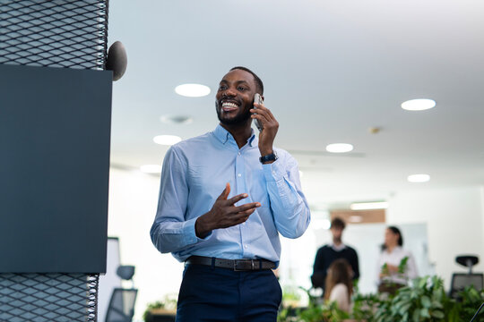 African american businessman talking on smartphone in office
