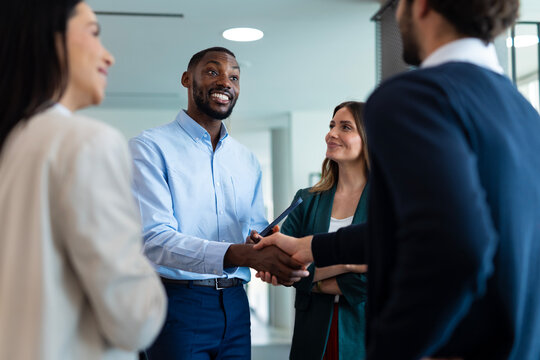 Diverse business professionals shaking hands making agreement