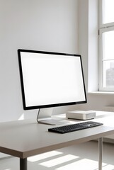 Fototapeta premium Computer with white screen on a modern desk, clean office environment, natural lighting, digital space for advertisements.