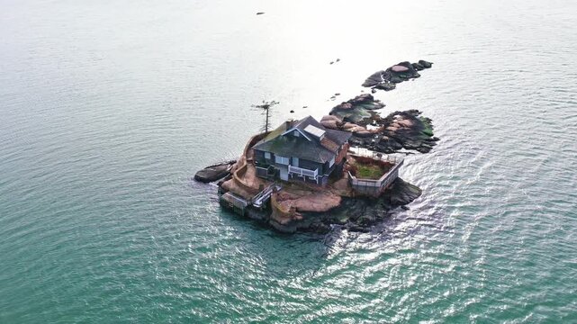 Isolated castaway house without connection to land. Island home designed for hermitage life. Solitary house settled on a remote island. Castaway retreat transformed into a hermit refuge.