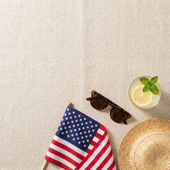 Obraz premium A refreshing summer picnic setup with a patriotic American flag, a straw hat, sunglasses, and a lemonade drink on a textured surface