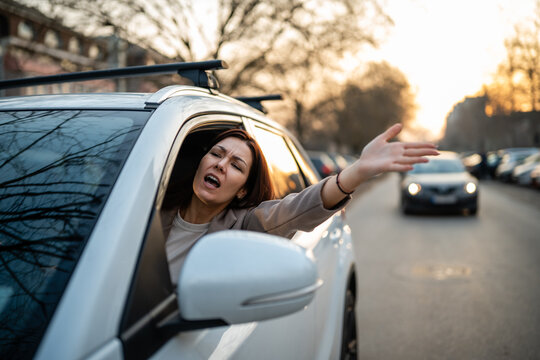 Woman driver expressing anger during road rage incident