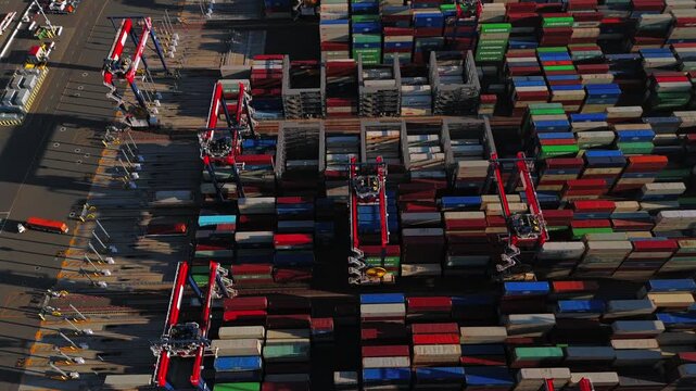Drone view of shipping containers and gantry cranes at Long Beach port