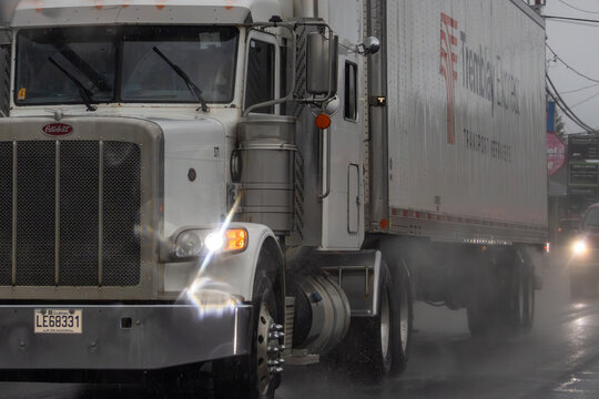 Canada, 13 April 2026 : Peterbilt truck with Tremblay Express trailer drives on a wet road during rain