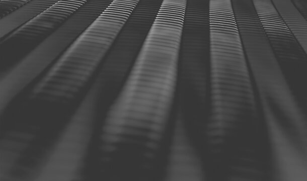 Dark ridged surface with parallel stripe line and soft diagonal light reflection