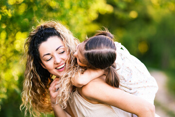 Fototapeta premium Mother with her cute little daughter in nature