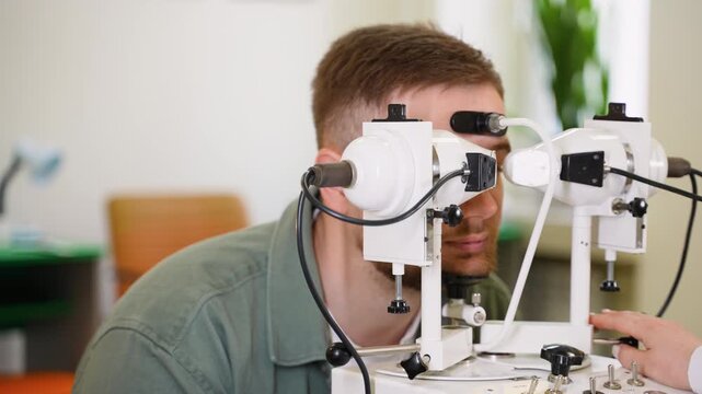Ophthalmologist checking patient's eyesight on special equipment